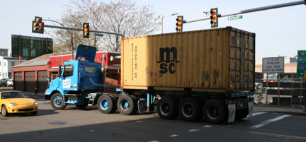 picture of medium sized container truck on East First Street